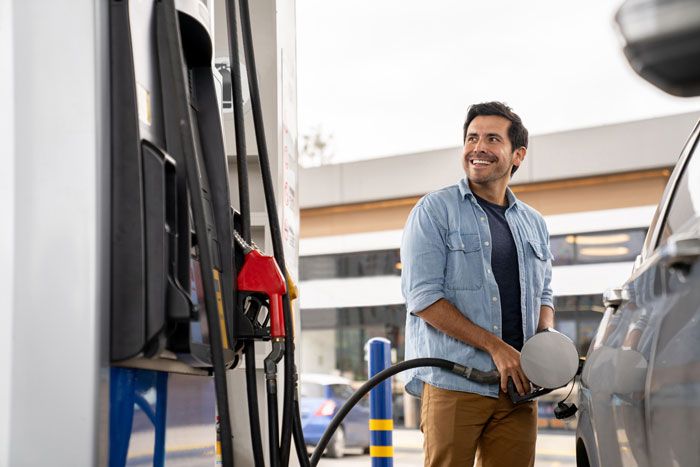 A man fuels his fleet vehicle at a Sunoco gas station.