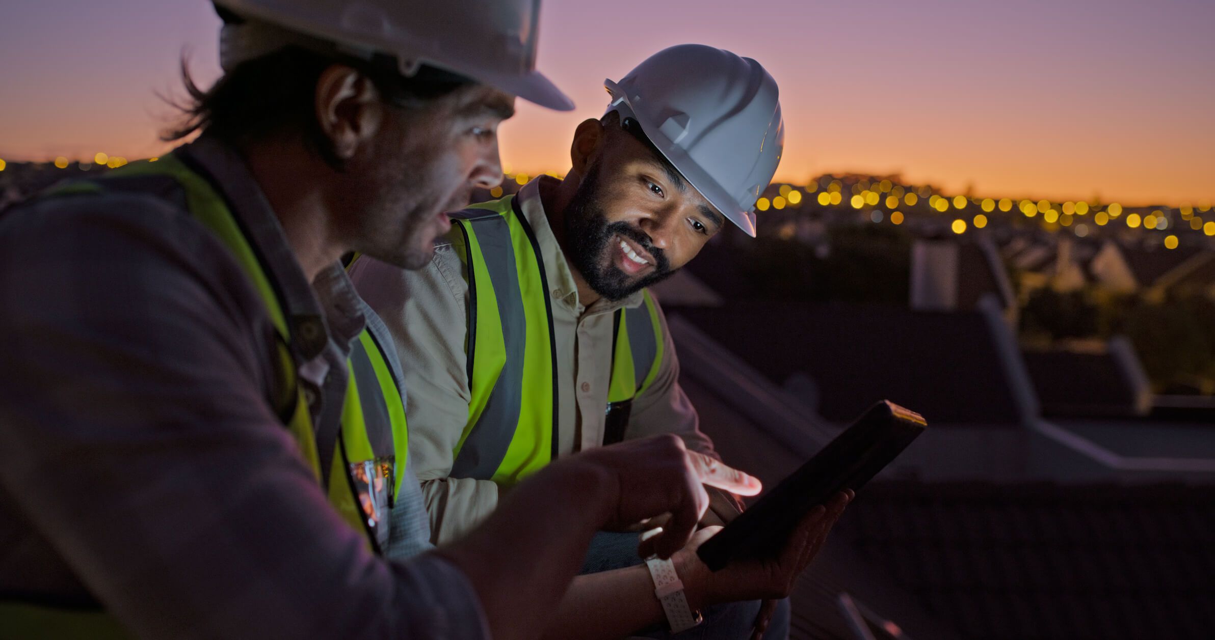A business owner reviews analytics of his fleet fuel card while at his construction site.