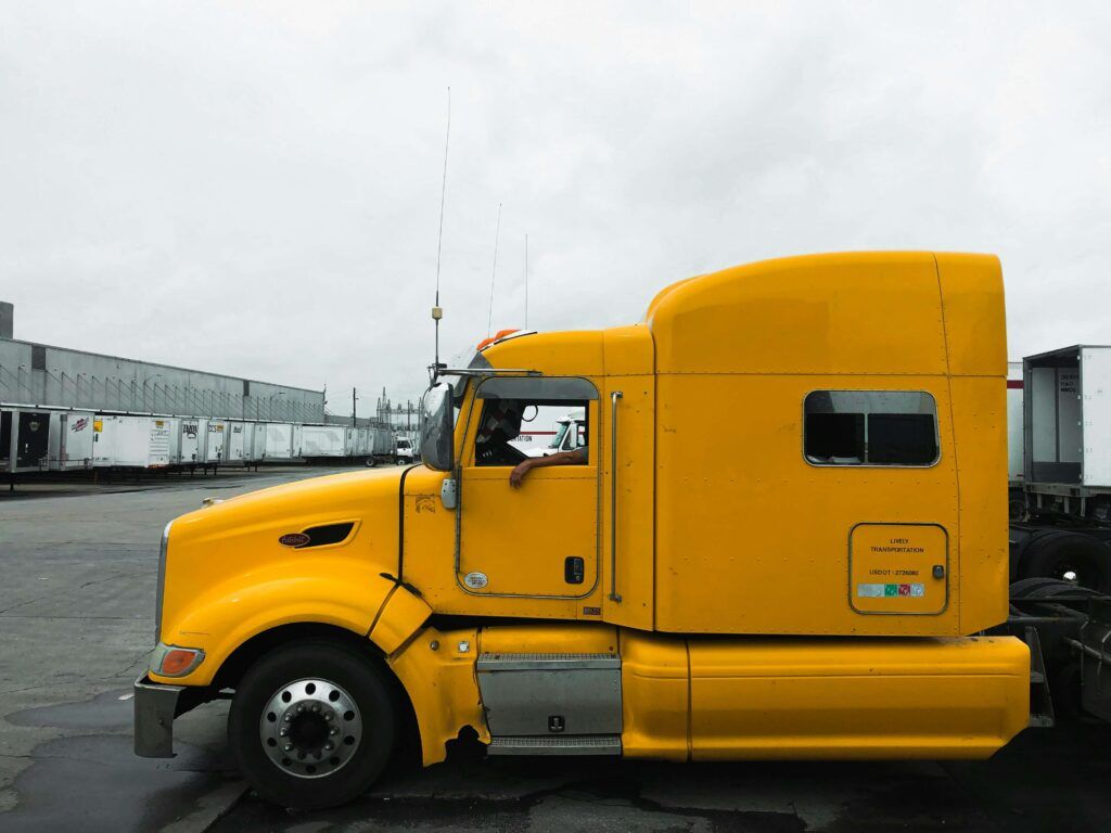 A truck from a fleet prepares to receive a load of goods to deliver.