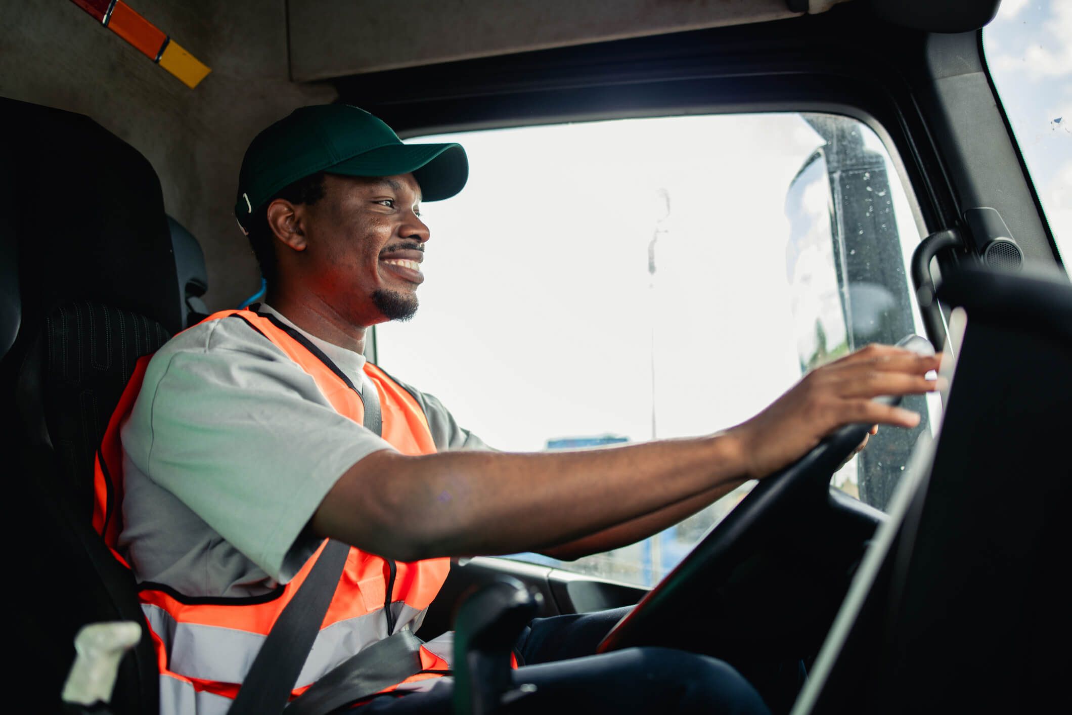 A fleet driver in the cab of his semi truck.