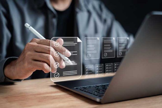 A manager going through a fuel card application on a laptop sees the digital checklist of documents needed for completion.