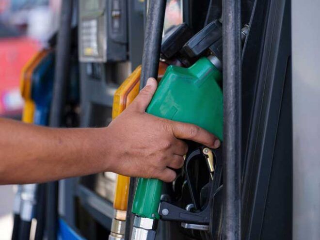 Image of a driver pumping fuel at a gas station.